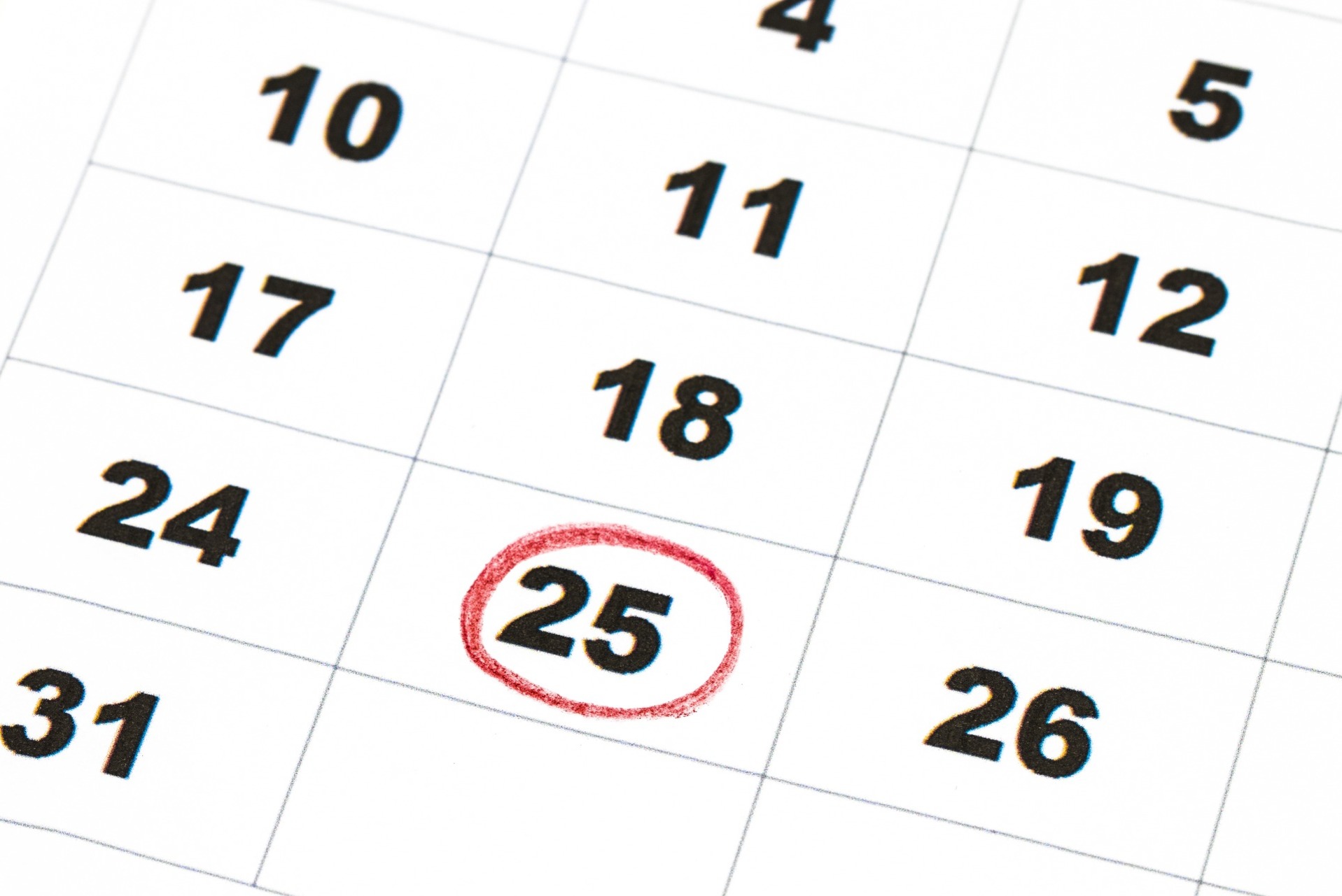 A calendar showing a date circled in red, being 25th; our Conveyancing Solicitors in Preston discuss property completion dates in the world of sales and purchases.